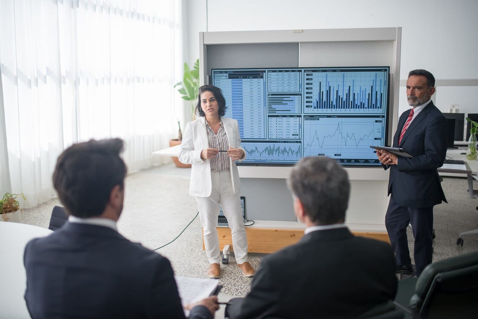 Team collaborating around a screen of analytics