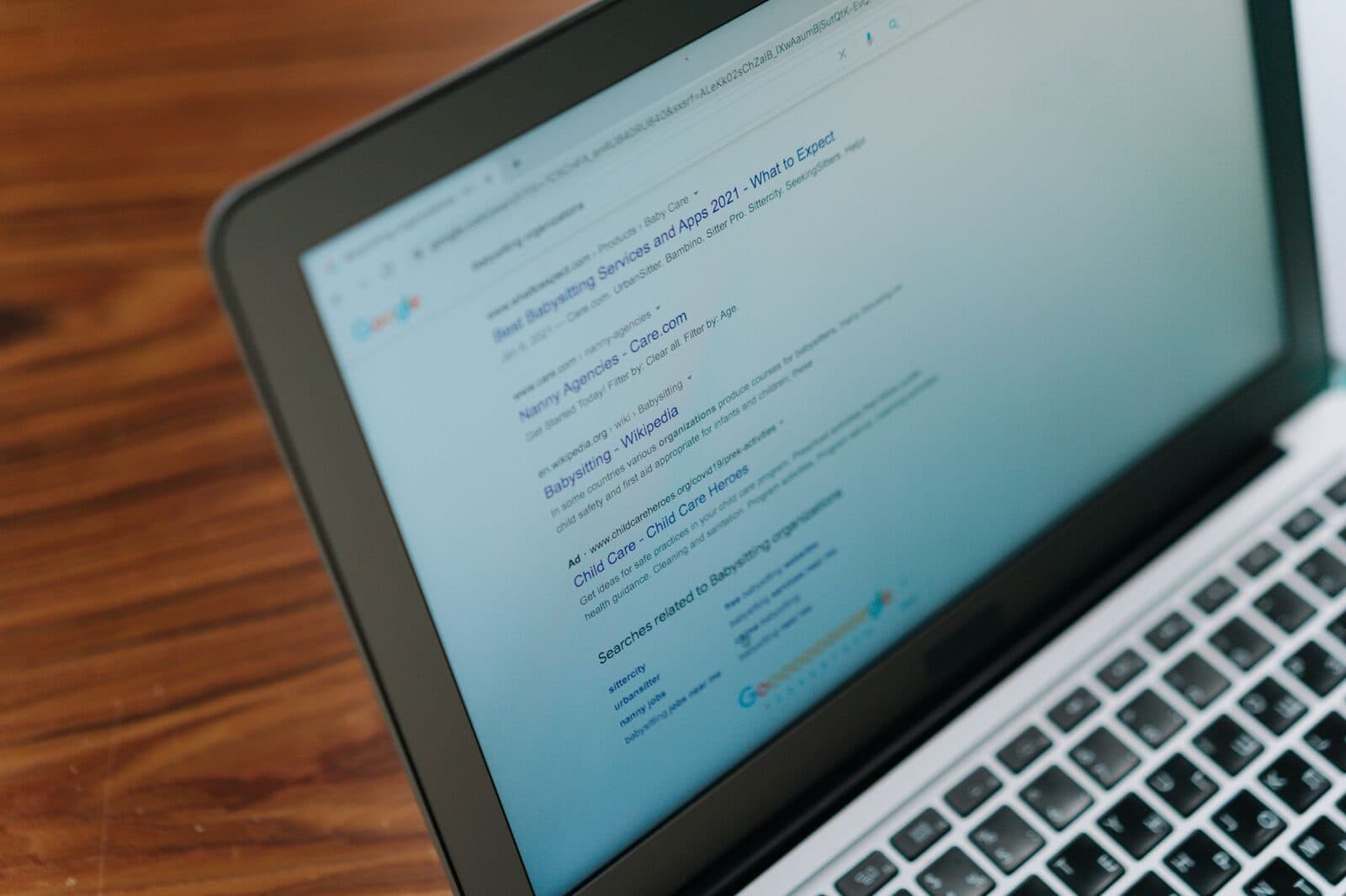 Analyst reviewing online search results on a laptop